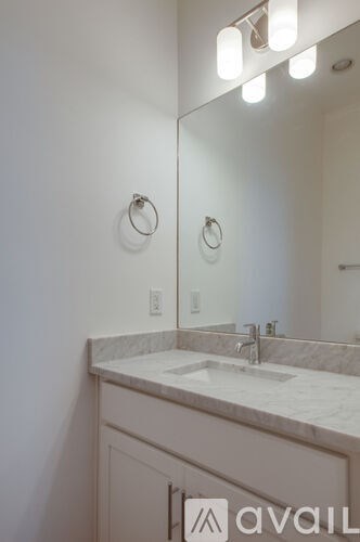 A bathroom with a sink and mirror.