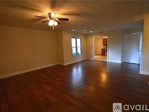 A room with wooden floors and a ceiling fan.