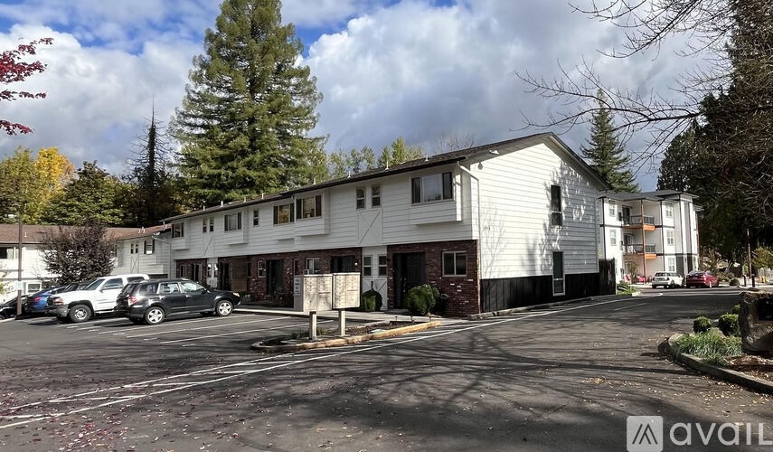 A parking lot in front of a building with a sign that says "available".