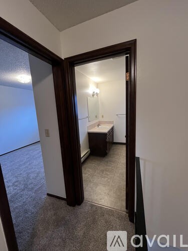 A bedroom with a bed and a mirror on the wall.