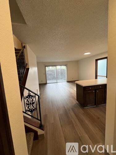 A view of a home interior with a staircase and a kitchen area.