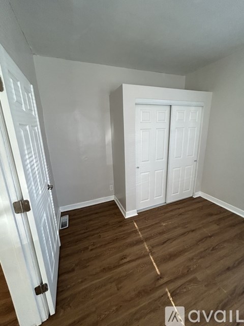 A room with a white door and a white closet door.