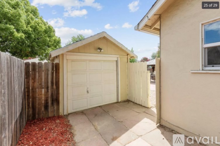 A garage with a white door is attached to a house.