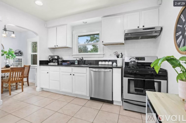 A kitchen with white cabinets and appliances.