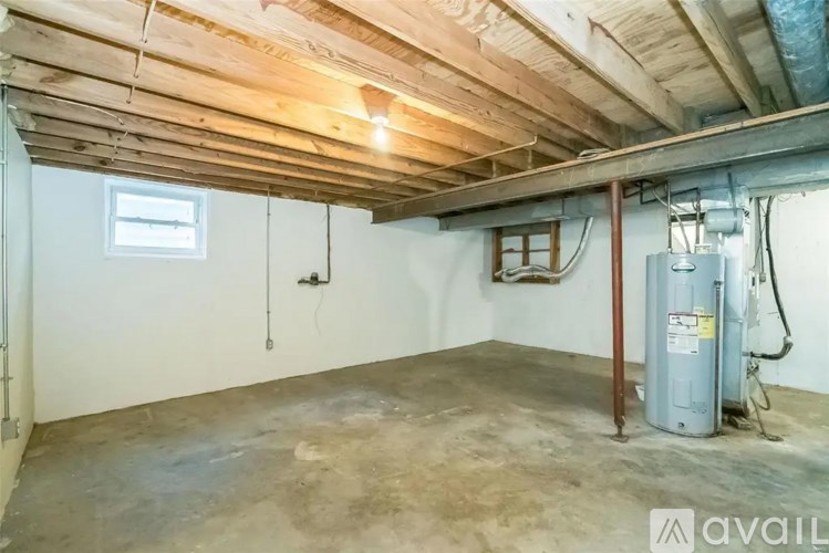 A room with a wooden ceiling and a window on the wall.