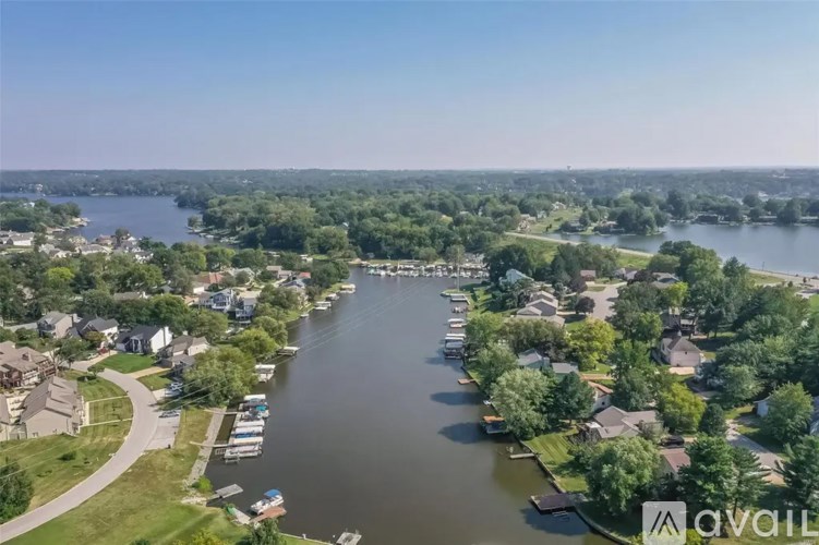 A river runs through a residential area with houses on both sides.