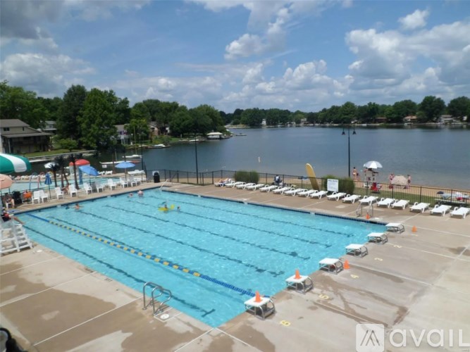 A large swimming pool with lanes and a diving board.
