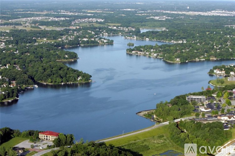 A large body of water surrounded by land with a building in the middle.