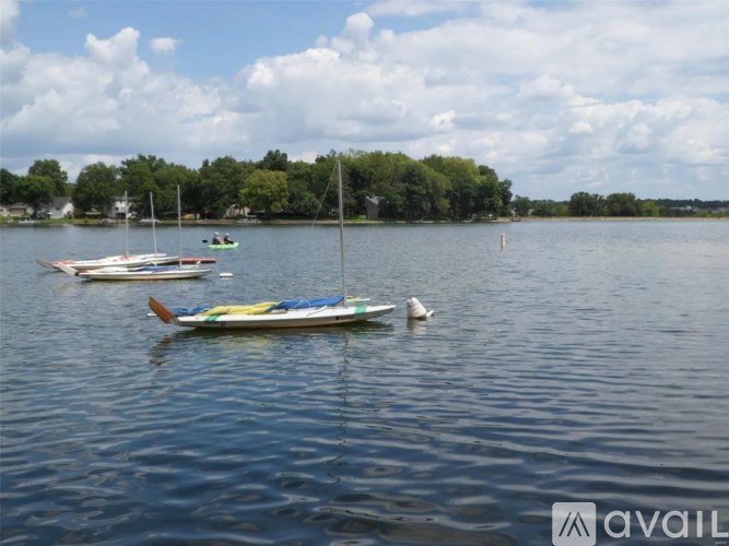 A group of boats are floating on a body of water.