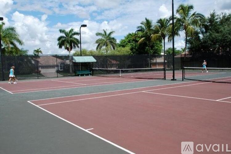 A tennis court with two players, one on each side of the net.