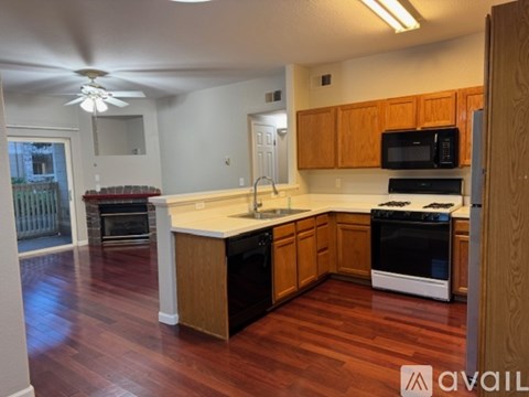 A kitchen with wooden cabinets and a white countertop.