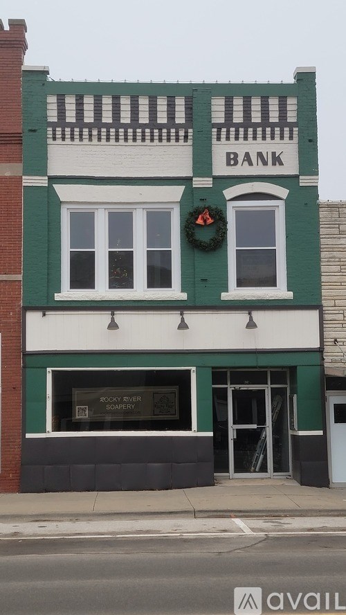 A bank building with a wreath on the window.