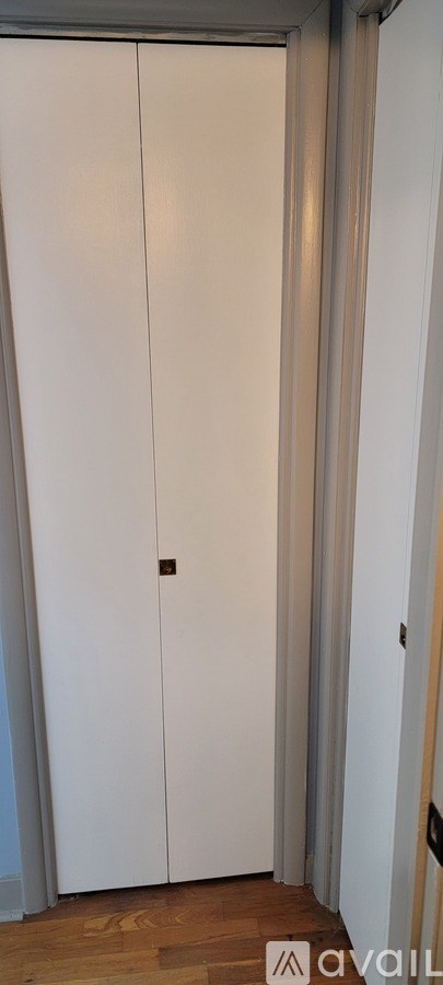 A white door with a brown handle is closed.