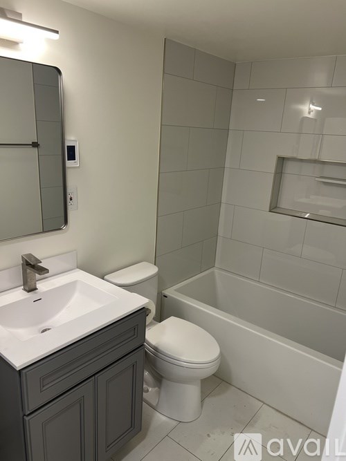 A bathroom with a toilet, sink, and tub.
