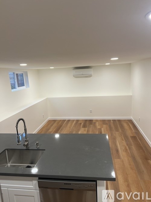 A kitchen with a sink and a window.