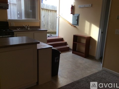 A kitchen with a brown counter top and a brown cabinet.
