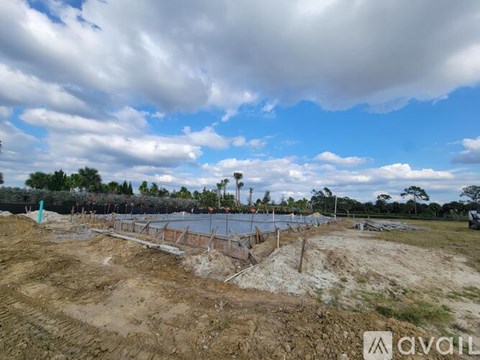 A construction site with a partly cloudy sky.