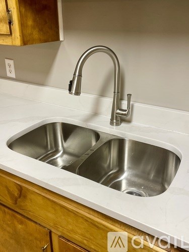 A kitchen sink with a faucet and a countertop.