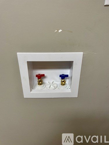 A white box with a red, blue, and gold object inside.