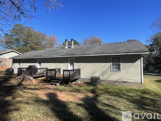 A house with a grey roof and a covered patio.