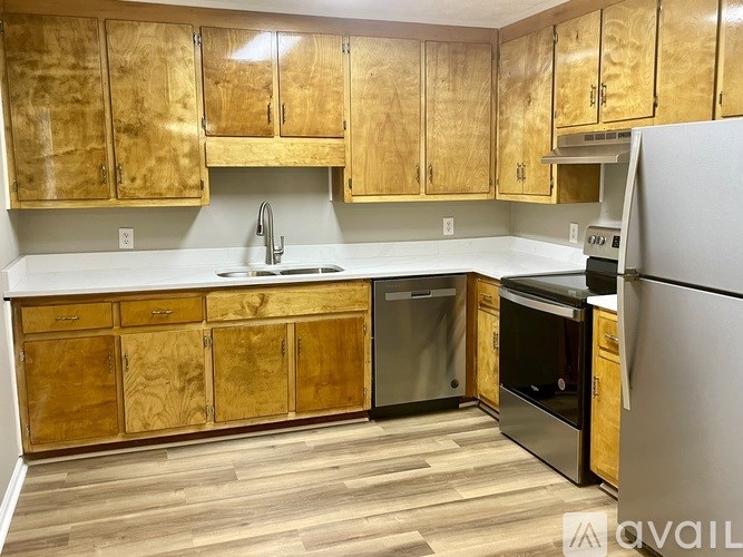 A kitchen with wooden cabinets and stainless steel appliances.