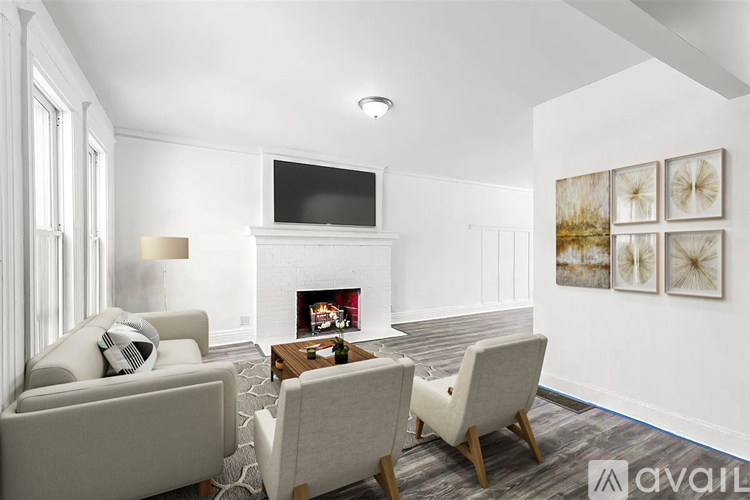 A living room with a fireplace, a television, and a painting on the wall.