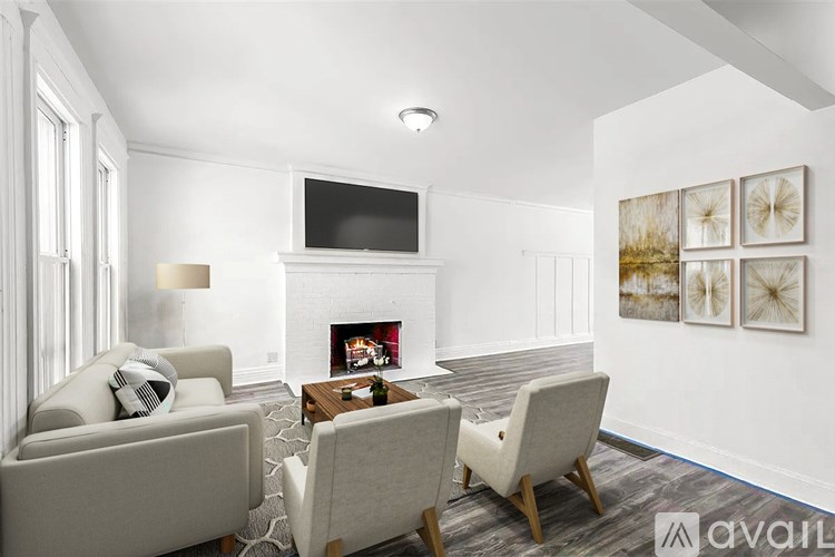A living room with a fireplace, a television, and a painting on the wall.