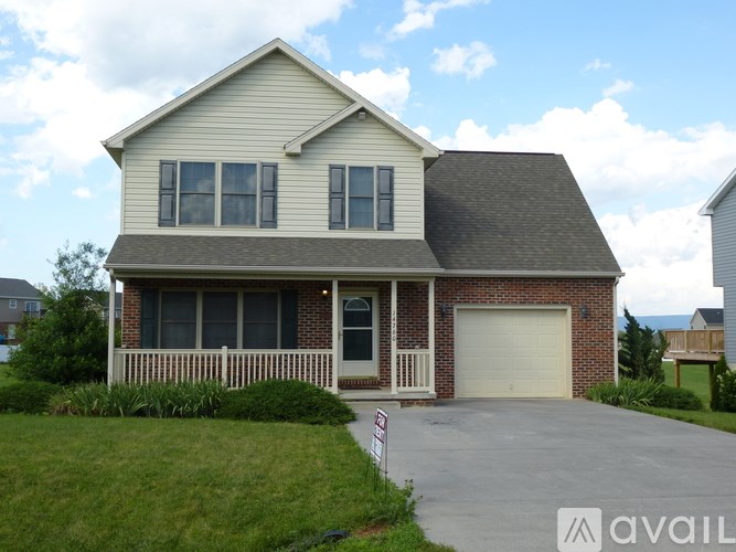 A house with a garage and a driveway is for sale.