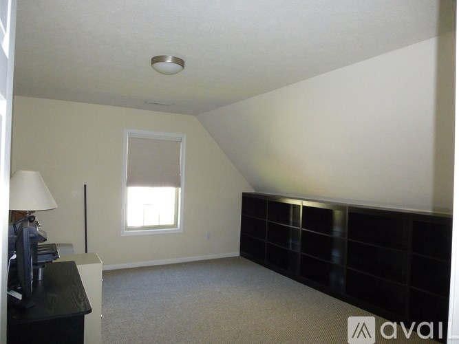 A room with a desk and a window.