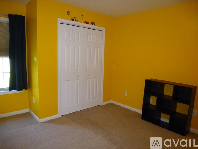 A room with yellow walls and a white door.