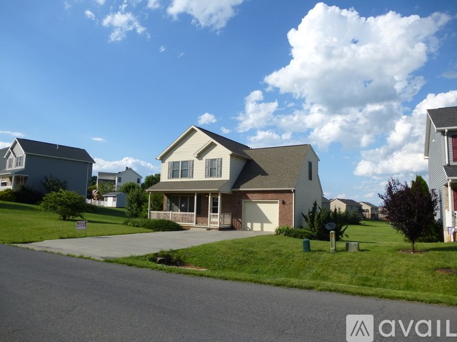 A house with a front yard and a sign that says "available".