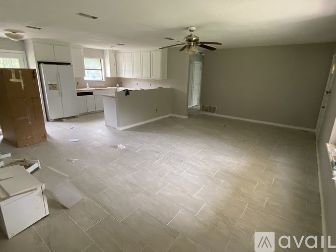 A room with a ceiling fan and tiled flooring is available for rent or purchase.