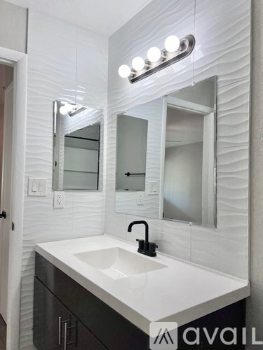 A bathroom with a sink and mirror.