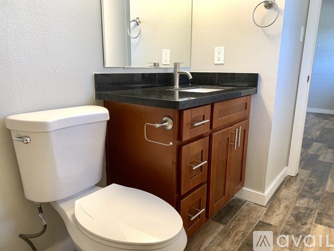 A white toilet sits next to a sink in a bathroom.