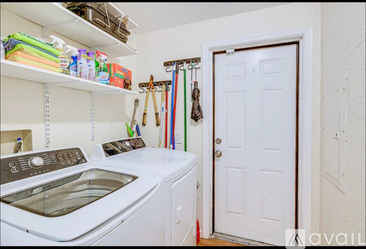 A small laundry room with a washer and dryer.