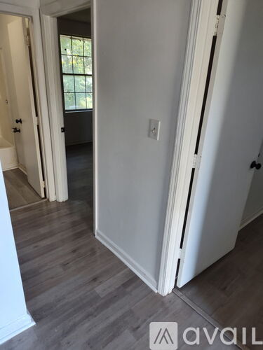 A white door is open to a hallway.