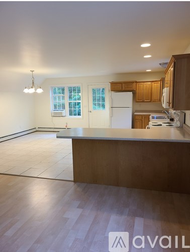 A kitchen with wooden cabinets and a white refrigerator.