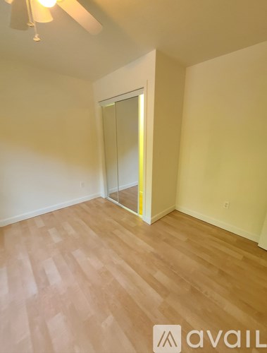 A room with wooden flooring and a glass door.