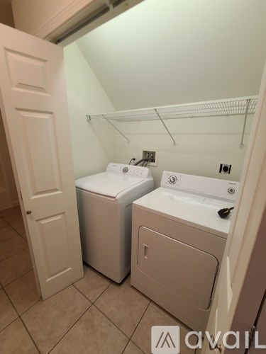 A small laundry room with a washer and dryer.