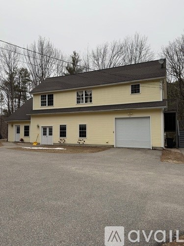 A two-story house with a garage is available for sale.