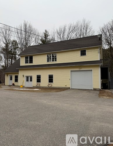 A two-story house with a garage on the right side.