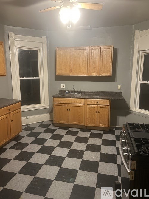 A kitchen with black and white checkered floor.