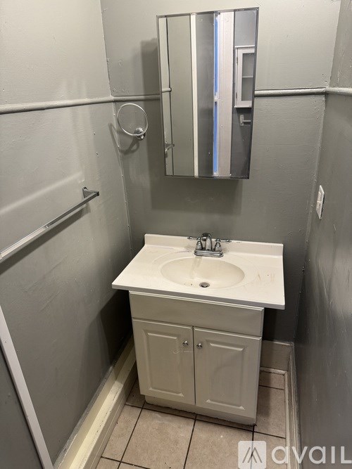 A small white sink in a small bathroom.