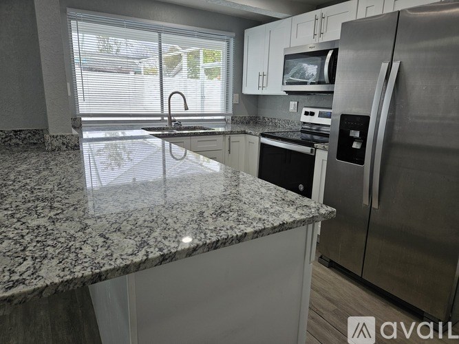 A kitchen with granite countertops and stainless steel appliances.