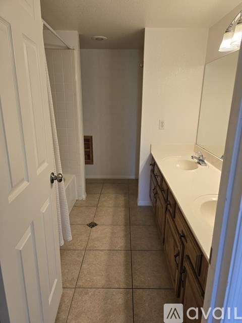 A bathroom with a white door and a white sink.