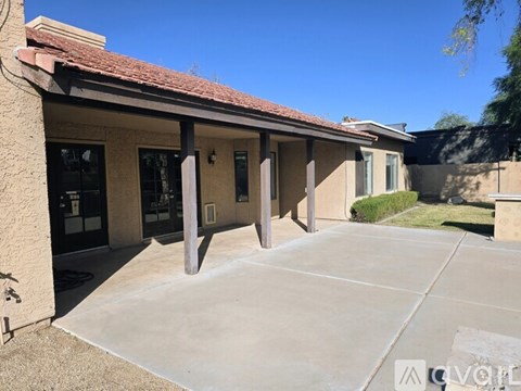 A building with a red roof and a concrete driveway.