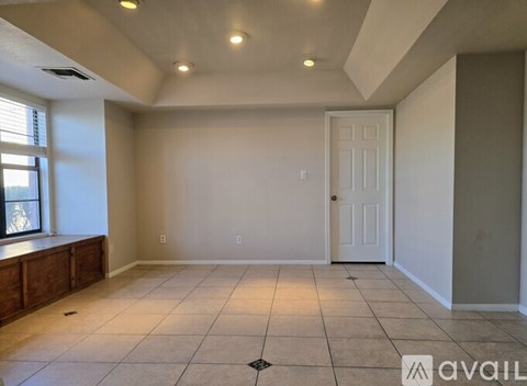 A spacious room with a door and a window.