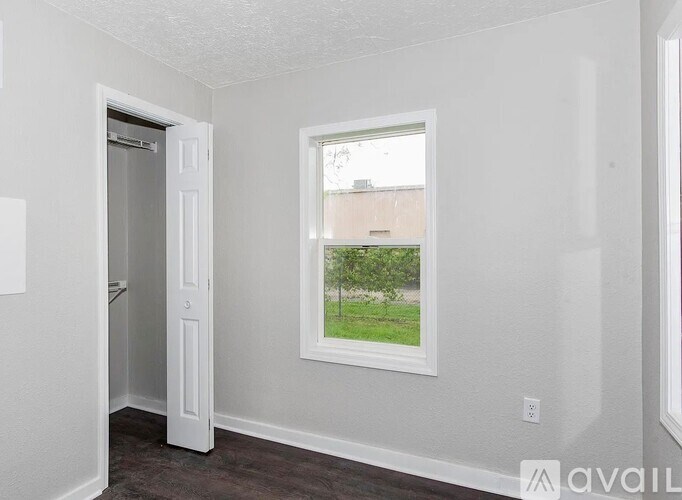 A room with a window and a door.