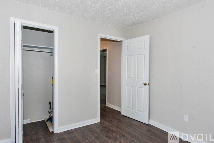 A room with a white door and a white wall.