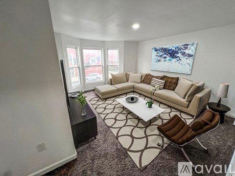 A living room with a brown chair and a white coffee table.